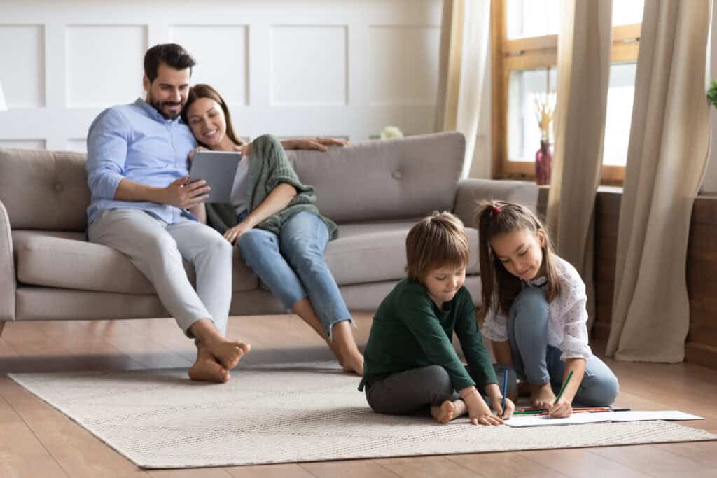 Family relaxing at home in a Phoenix area neighborhood with kids playing in the living room