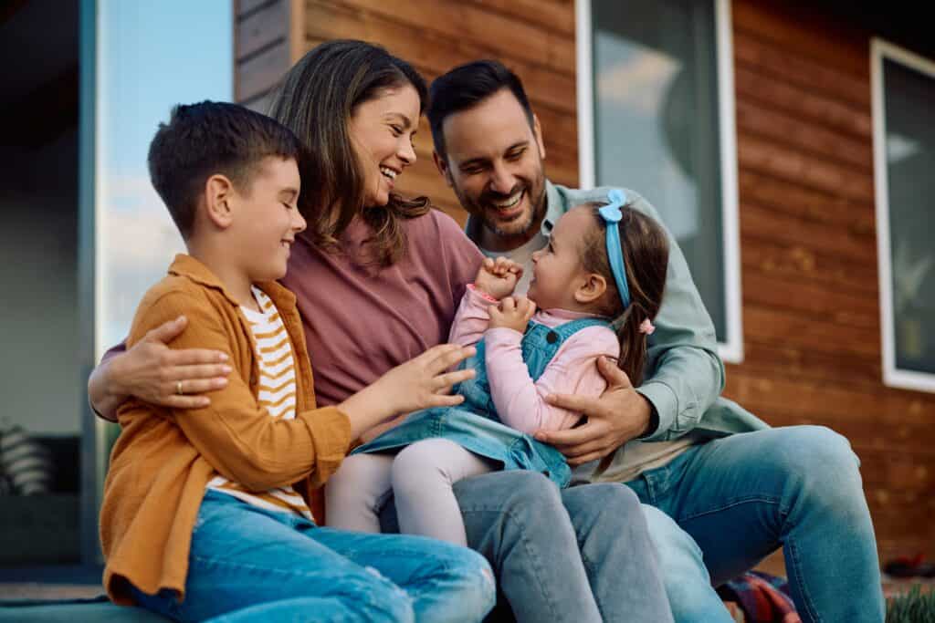 Phoenix Area Family Outside Their New Home | Red Penny Realty First time buyer enjoying each other at their new home