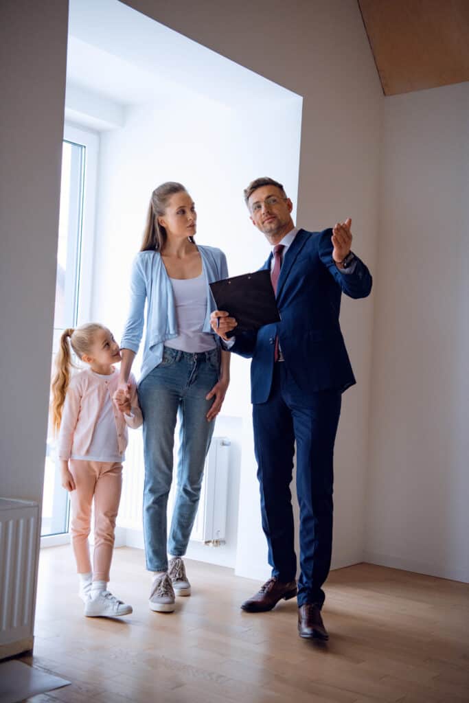 Mesa Real Estate Agent Showing Home to Family Buyers | Red Penny Realty Mesa real estate agent preparing a mother who is ready to sell her home