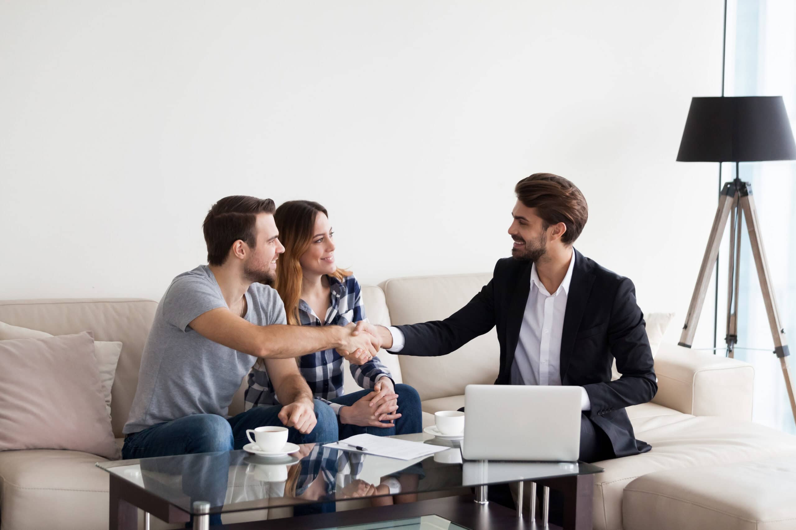 Phoenix Real Estate Agent Closing Deal With Home Buyers | Red Penny Realty Phoenix realtor shaking hands with home buyers after closing a real estate deal in the greater Phoenix AZ area